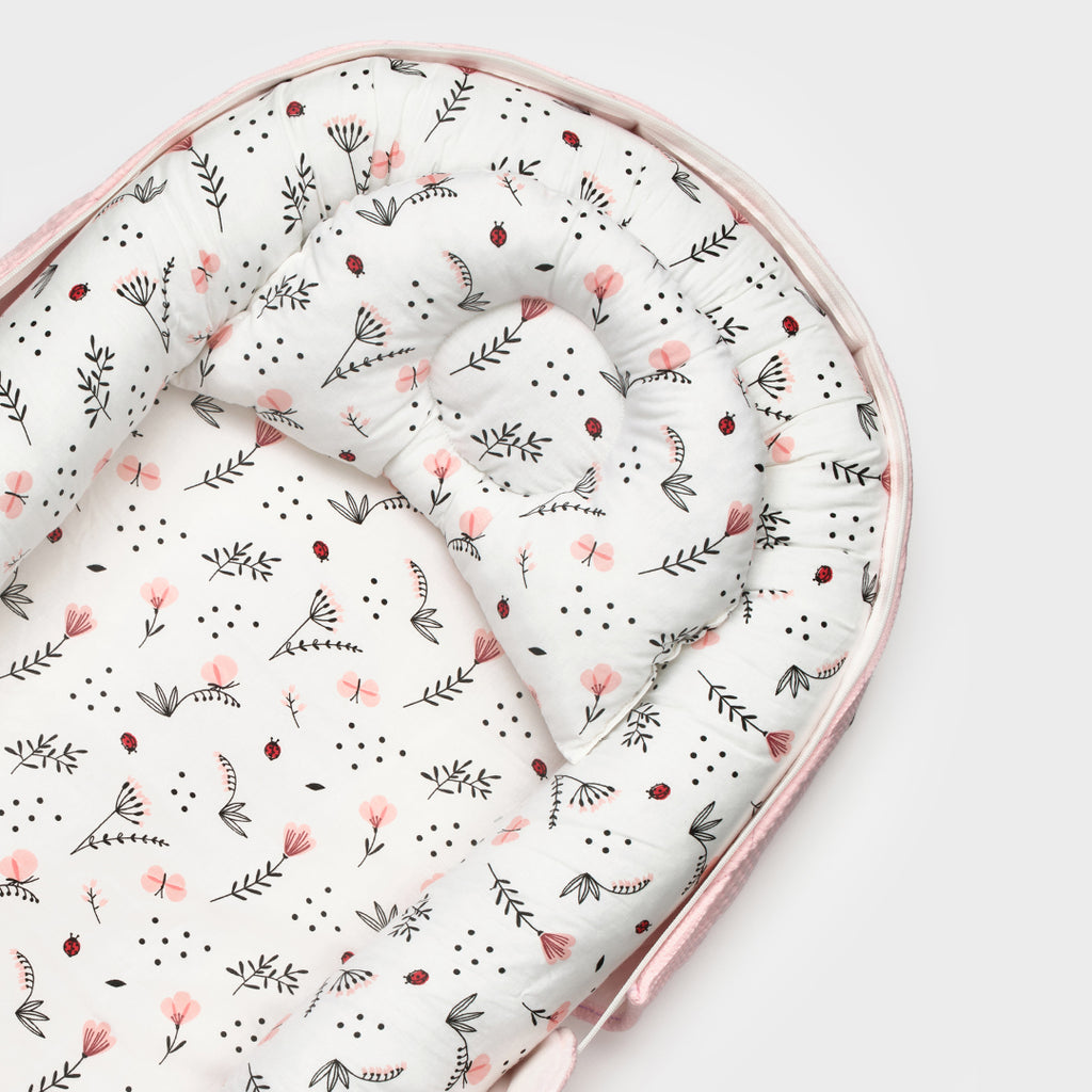 BabyOne portable cradle for Barbie "الحضن المتنقل" with pink and purple design, showing the compact, easy-to-carry baby doll bed.