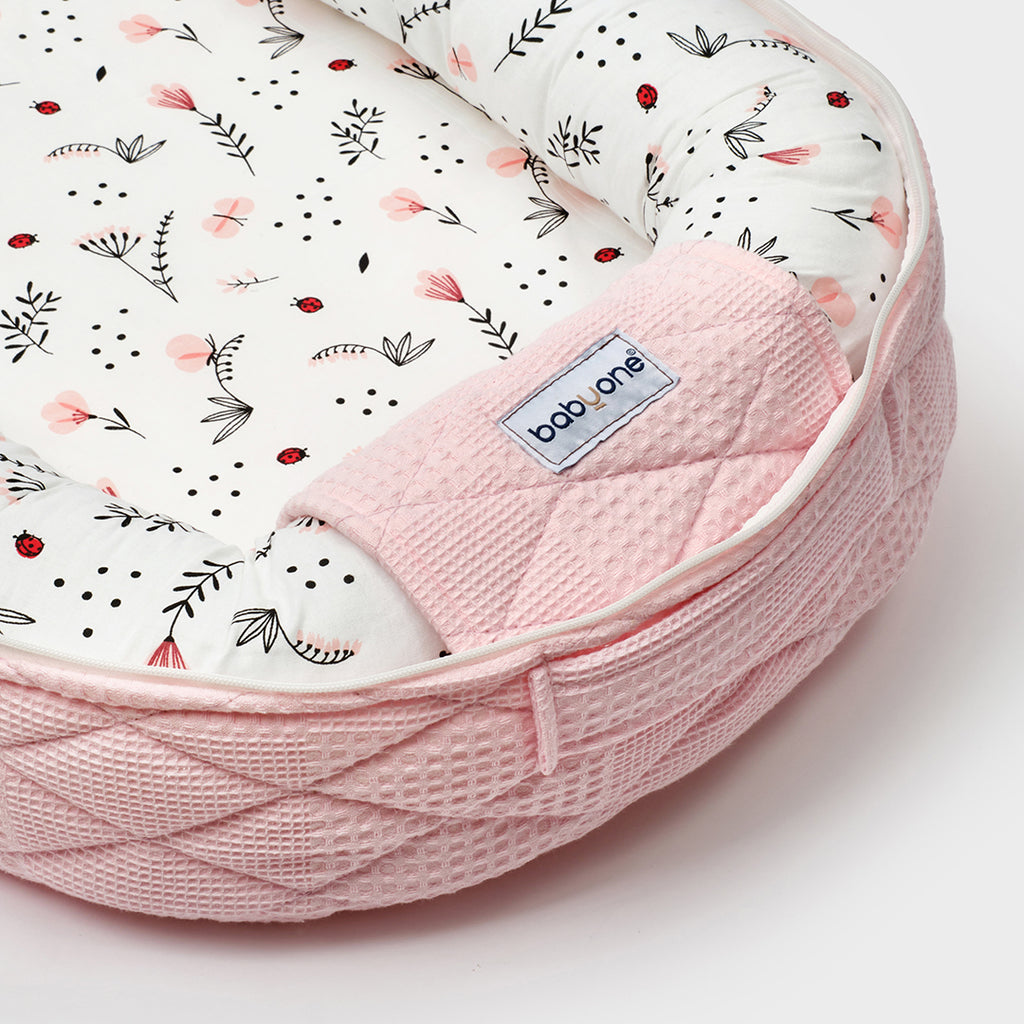 BabyOne portable cradle for Barbie "Handoff" plush toy with a soft, pink fabric bed and a carry handle.