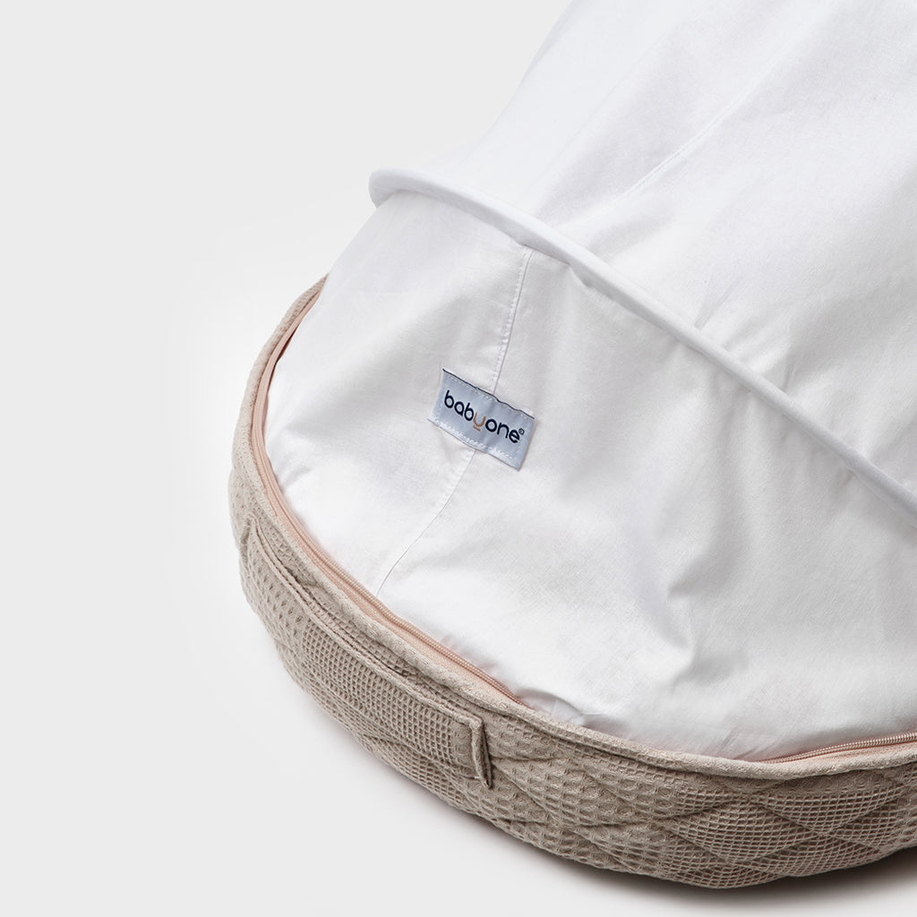 BabyOne portable crib with soft loungewear and sugar-themed design, suitable for infants and easy to carry.
