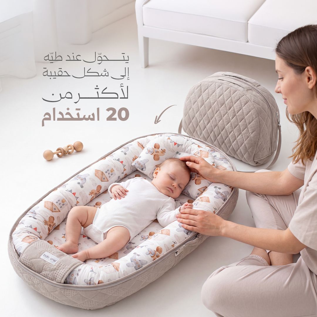 BabyOne portable crib with soft bedding and colorful design, ideal for infants and easy to carry for on-the-go comfort.